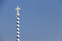 Cross on a striped pole.