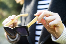 a woman holding sunglasses 