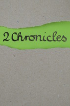 torn open kraft paper over green paper with the name of the 2 book of Chronicles