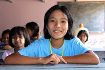a smiling girl in a classroom 
