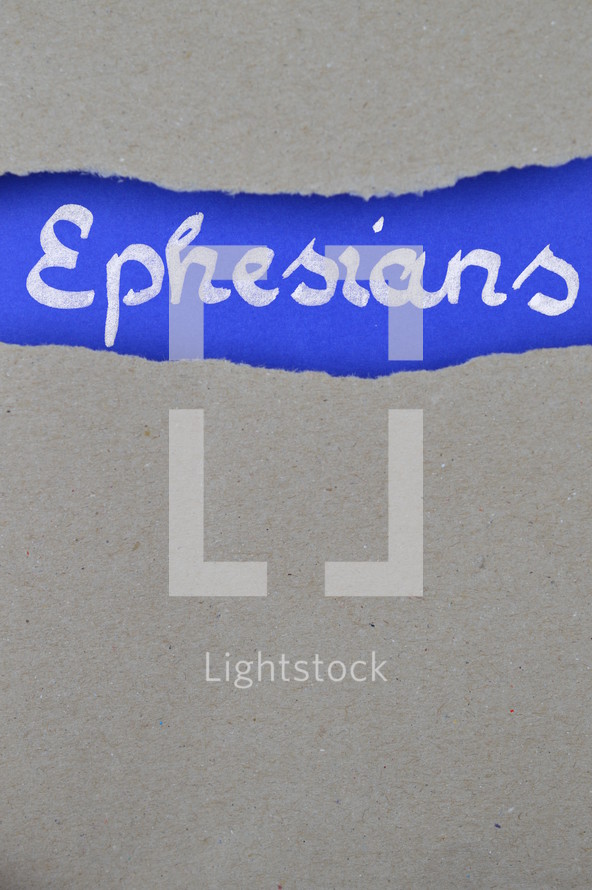 Ephesians - torn open kraft paper over intense blue paper with the name of the letter from Paul to the  Ephesians