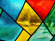 Stained Glass window detail showing types of glass and colors reflecting in the stained glass window in a local church building. 