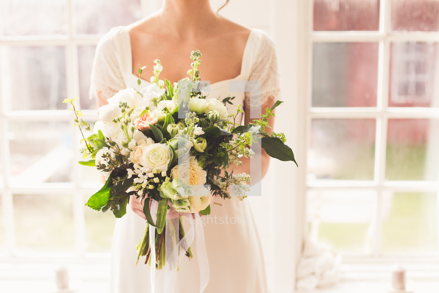 a bride holding a bridal bouquet 