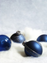 blue Christmas ornaments in snow