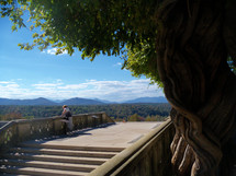 a woman looking at a scenic Mountain View from a balcony in Scenic Asheville, North Carolina. 
