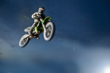 A man on a motorcycle flying through the air.