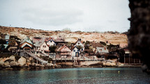 houses built into cliffs along a shore 