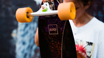 a woman holding a skateboard 
