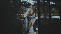 wind blowing a scarf and hair in a woman's face