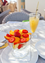 Cup of fruit salad with orange juice