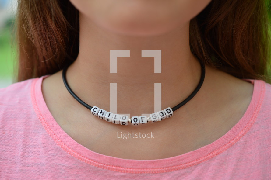 Child of God necklace around a woman's neck 