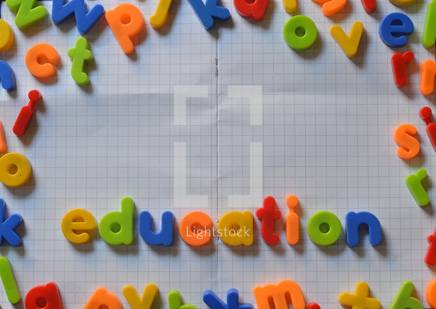 the word education written in colorful magnetic letters on an exercise book.  