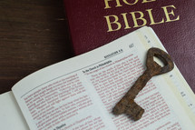 rusty key on the pages of a Bible 