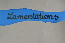 Lamentations - torn open kraft paper over blue paper with the name of the prophetic book Lamentations