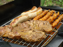 BBQ with friends. 
BBQ, barbecue, grill, cook, party, broil, cook out, grilling, friends, invite, invitation, summer, steak, sausage, sausages, steaks, celebrate, revel, together, dinner, lunch, hot, summertime, outside
