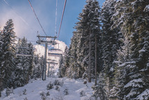 Sun and snowy cable car in the winter resort