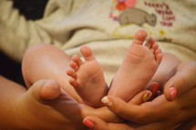 a mother holding a newborn 