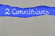 title 2 Corinthians exposed under gray torn paper 