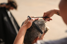 a man getting a haircut 