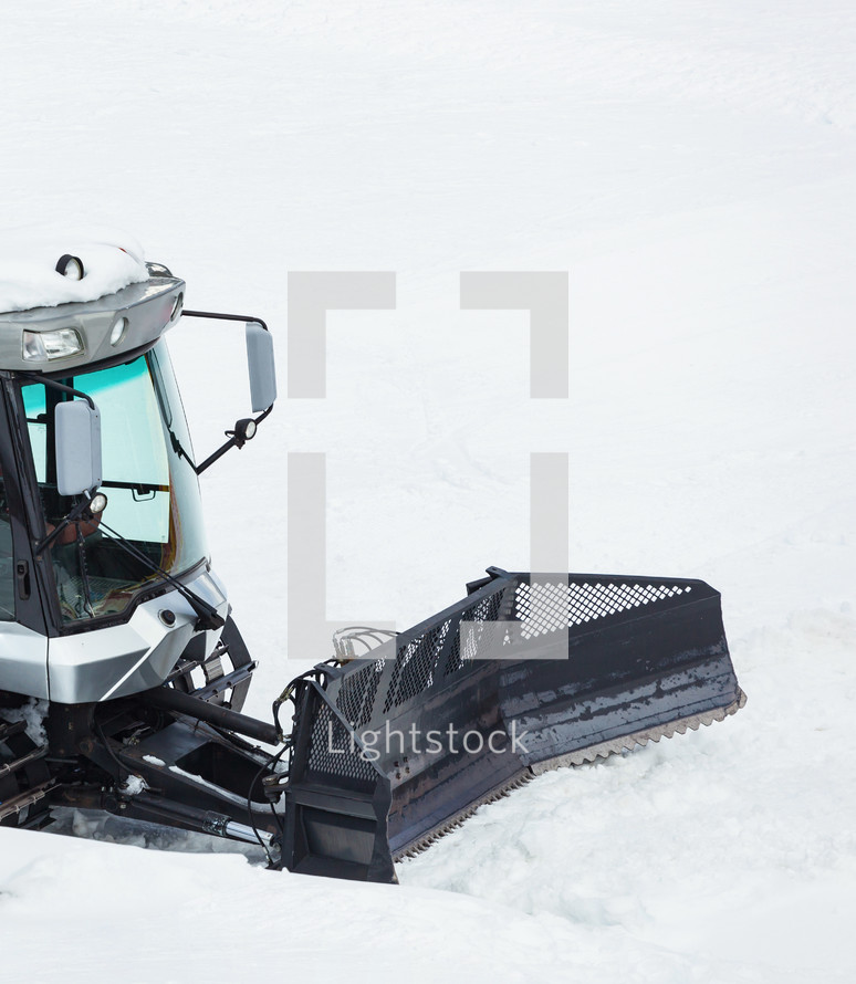 Piste machine, snow cat. Snowmobile governing snowy mountain road.