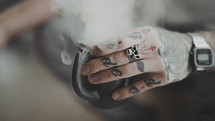 steaming mug and tattooed hands 