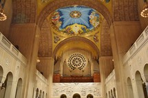organ pipes and painting on a dome ceiling 