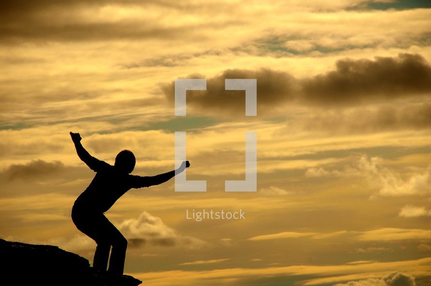 silhouette of a boy jumping 