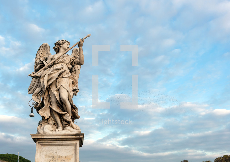 Statue of an angel standing on the bridge leading to the Castle Sant'Angelo, Rome.
