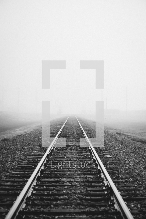 fog over railroad tracks 