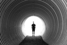 a man standing in a tunnel 