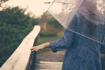 a woman walking under an umbrella 