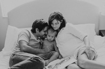 a mother and father reading a toddler a bedtime story 