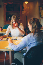 Women having a Bible study in a restaurant.