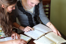 Two females studying the Bible together.