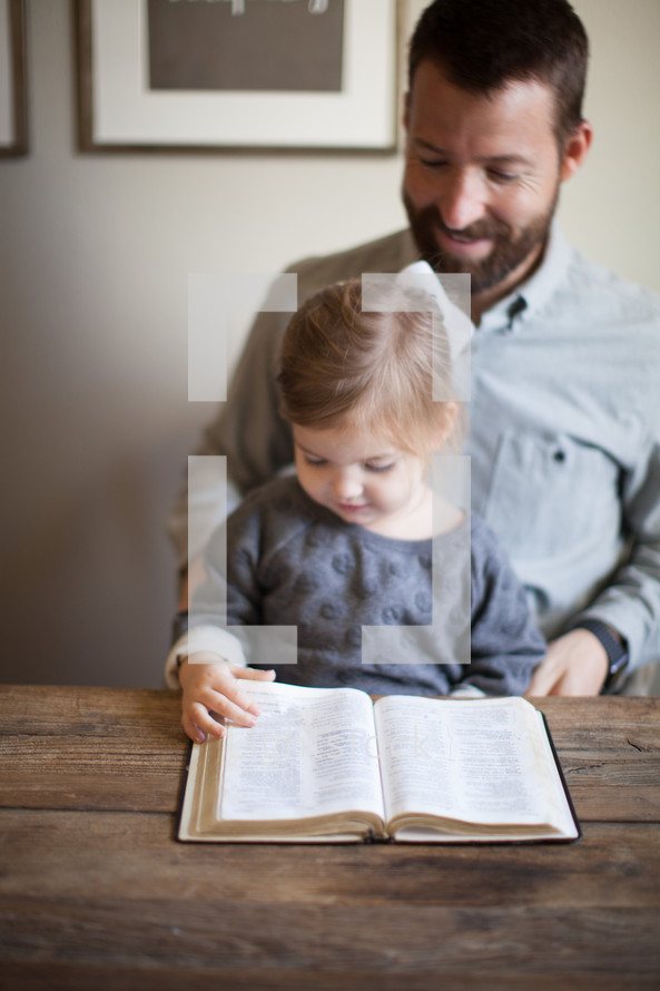 father and daughter reading a Bible 