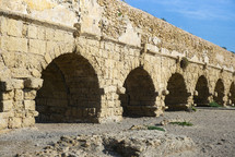 ancient ruins of Roman aqueduct near the city of Caesarea on the coast of Israel