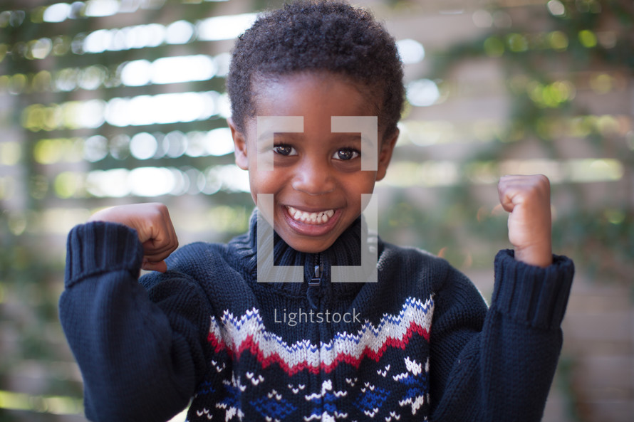 boy child showing his muscles 