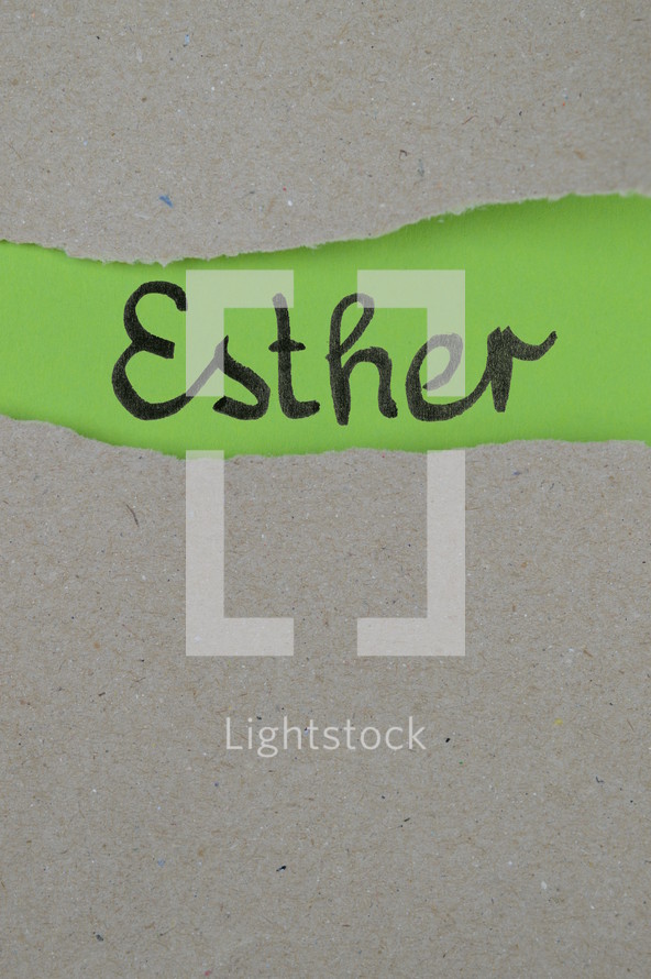 torn open kraft paper over green paper with the name of the book Esther