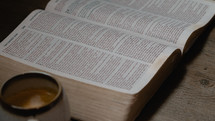an opened Spanish Bible and coffee cup 