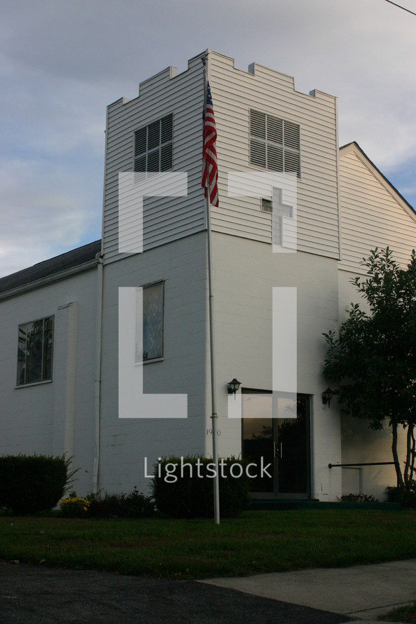 American flag on a flagpole on a church 
