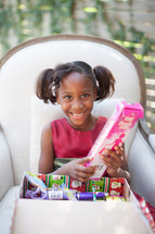 girl child opening a Christmas gift 