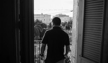 man standing on a balcony in Havana