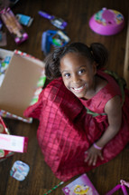 a girl child opening Christmas gifts 