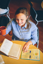 Woman drinking coffee at a Bible study.