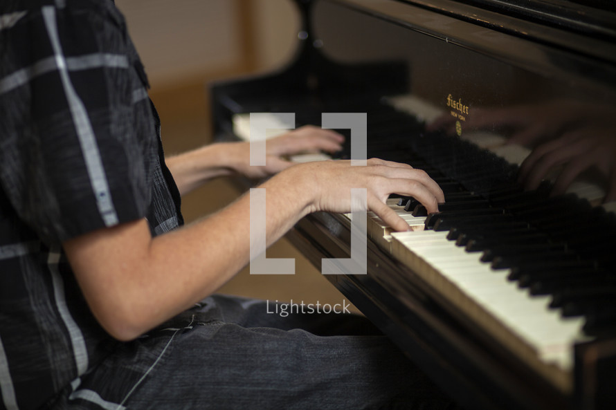 young man playing a piano 