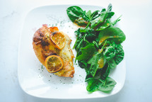 baked chicken and salad on a plate 