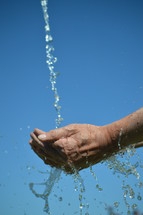 water flowing from the sky into open cupped hands
