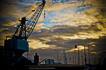 Crane in an industrial area at dusk.