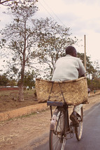 A man riding a bicycle in Malawi Africa. 