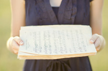 woman holding sheet music